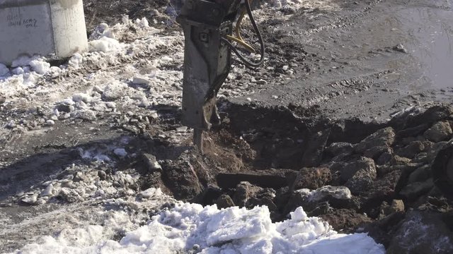 Breaker (hydraulic) cuts frozen soil stock footage video
