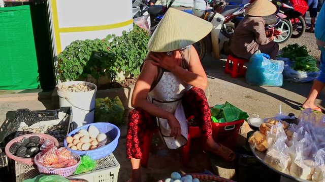 Woman in Hat Sells Products Eggs at Street Market in Vietnam
