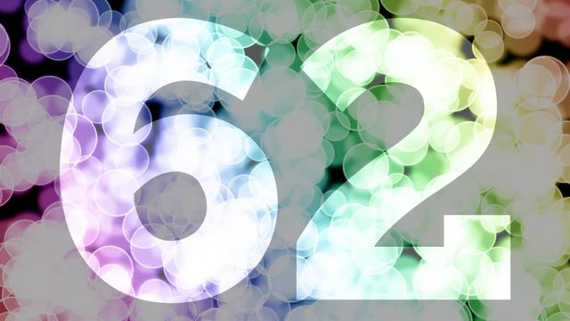 Sixty two to sixty three years birthday fade in/out animation with color gradient moving bokeh background. Animation: 90 frames still with number, 180 fade out, 30 clear, 180 fade in, 300 still.
