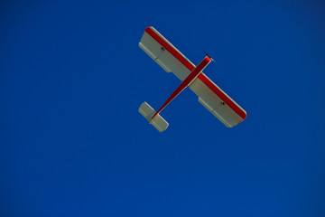 Airplane model flying in a summer sky