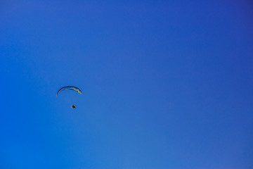 Paragliding flight with blue sky and some clouds