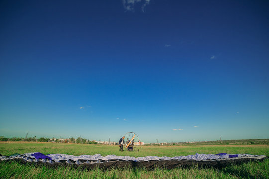 Man is preparing a motor paraglider for the start