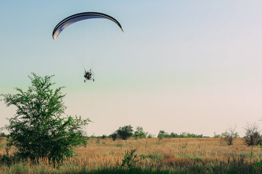 Paragliding flight with blue sky and some clouds