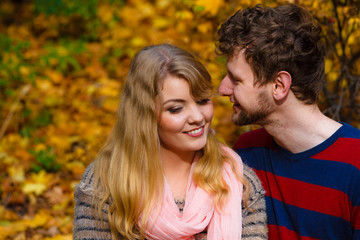 Lovers couple in autumn park on bench