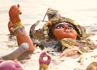 Immersion of goddess durga idol in river after completion of festival