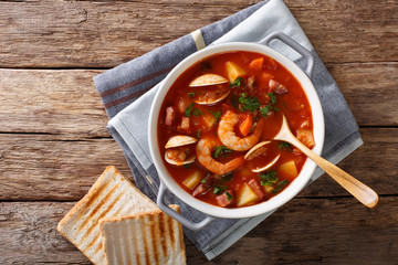 Manhattan clam chowder soup close-up. horizontal top view