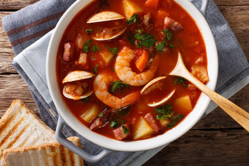 Manhattan tomato clam chowder soup close-up in a saucepan. horizontal top view