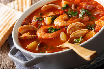American cuisine: Manhattan clam chowder soup closeup. Horizontal