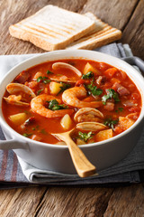 Manhattan clam chowder soup close-up. vertical