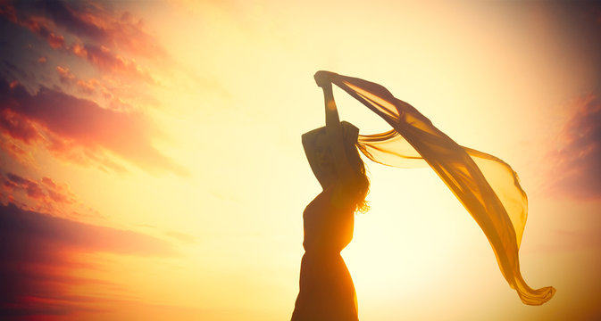 photo of beautiful young woman with shawl on the wonderful sunset background