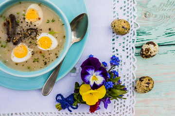 Traditional Easter rye sour soup with quail eggs, bacon and potatoes. 
