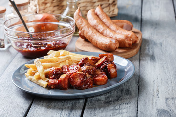 Traditional German currywurst - pieces of sausage with curry sauce