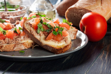 Appetizer bruschetta with tuna, mozarella cheese and tomatoes