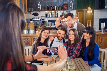 Friends do selfie on the phone at  bar restaurant.