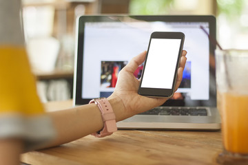 Selective focus of women hand holding white blank screen(Clipping path) smartphone.