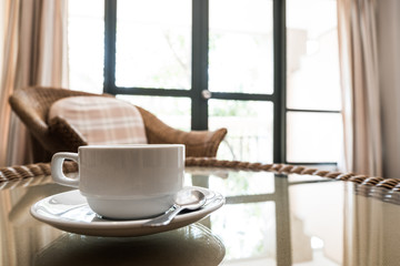 Close up a cup of coffee in living room.