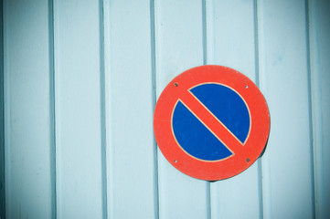 no parking sign on a turquoise garage door