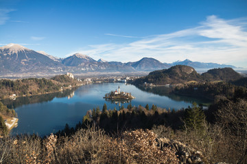 travel to colorful picturesque landscape with stunning lake bled and island surrounded by julian...
