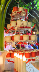 The cupcakes stand with beautiful candle in blurred background