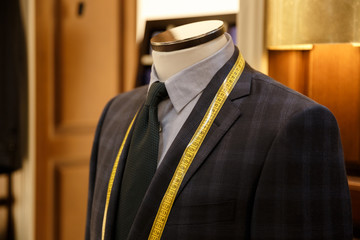 Close up shot of men suit and tie hanging in wardrobe