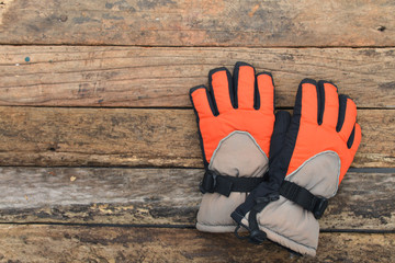 Winter gloves on natural wooden table background. Concept of skiing or snowboarding.