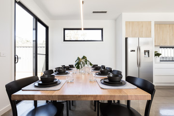 Table setting details of charcoal crockery and felt grey place mats