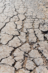 Old worn and cracked asphalt with cracks