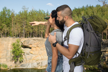 Happy young couple enjoying the hike in the woods © Nestor