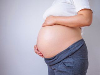 pregnant woman touching her belly