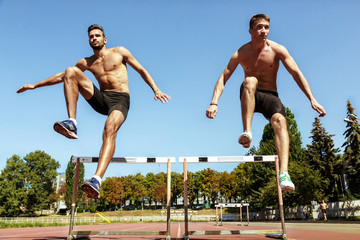 Two athletes running in a race at the stadium