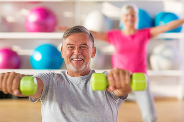 Mature couple doing fitness exercises