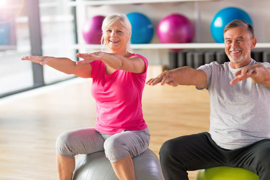 Mature couple doing fitness exercises