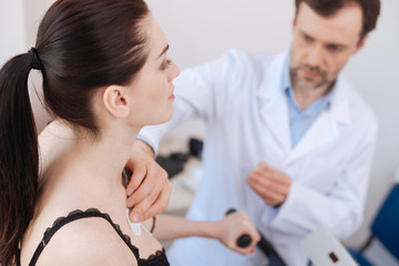 Skillful professional cardiologist using electrodes for diagnostics