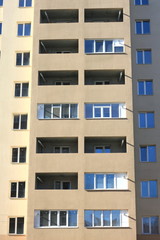 Fototapeta na wymiar Facade of a beautiful multi-storey modern building with windows and balconies close-up