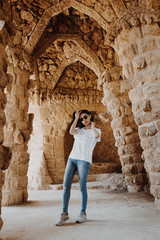 Fototapeta na wymiar Young woman posing in Park Guell in Barcelona