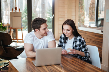 Using laptop and talking