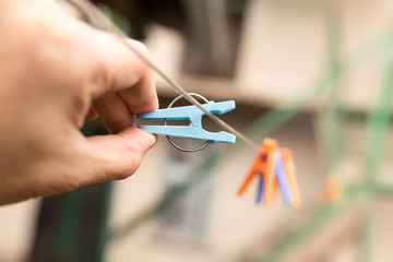 Clothespin in a hand on a clothesline