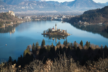 panoramic view on lake bled from above in sunny blue sky surrounded by julian alps mountains, bled,...