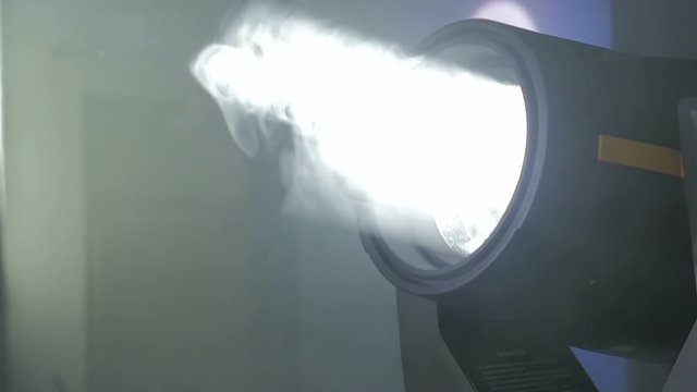 White searchlight moves in the darkness, HD, 1920x1080. Searchlight