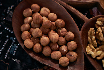 Set of different nuts, almonds, walnuts, hazelnuts  in brown wooden bowl. Close-up