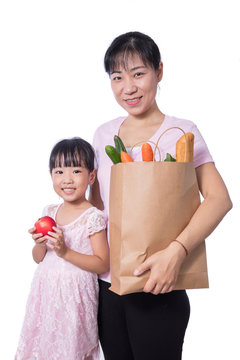 Asian Woman And Daughter Carrying Groceries