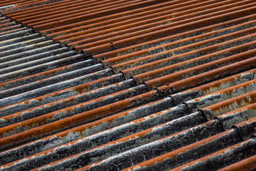 The old and rusty iron roof of a building