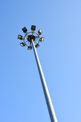 A football stadium spotlight with blue sky
