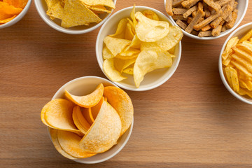 Pretzels in bowls on wooden table from above