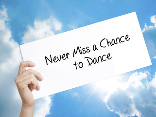 Never Miss a Chance to Dance Sign on white paper. Man Hand Holding Paper with text. Isolated on sky background