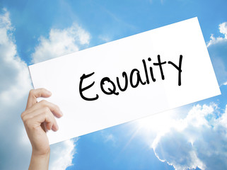 Equality  Sign on white paper. Man Hand Holding Paper with text. Isolated on sky background