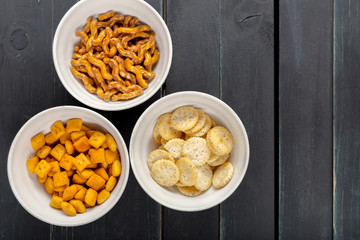 Pretzels in bowls on wooden table from above