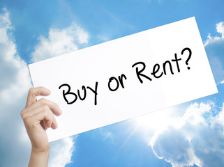 Buy or Rent? Sign on white paper. Man Hand Holding Paper with text. Isolated on sky background