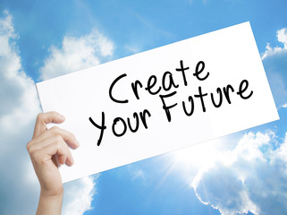Create Your Future Sign on white paper. Man Hand Holding Paper with text. Isolated on sky background