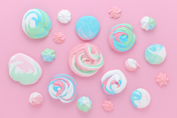 meringues in pastel colors, pattern abstract on pink background